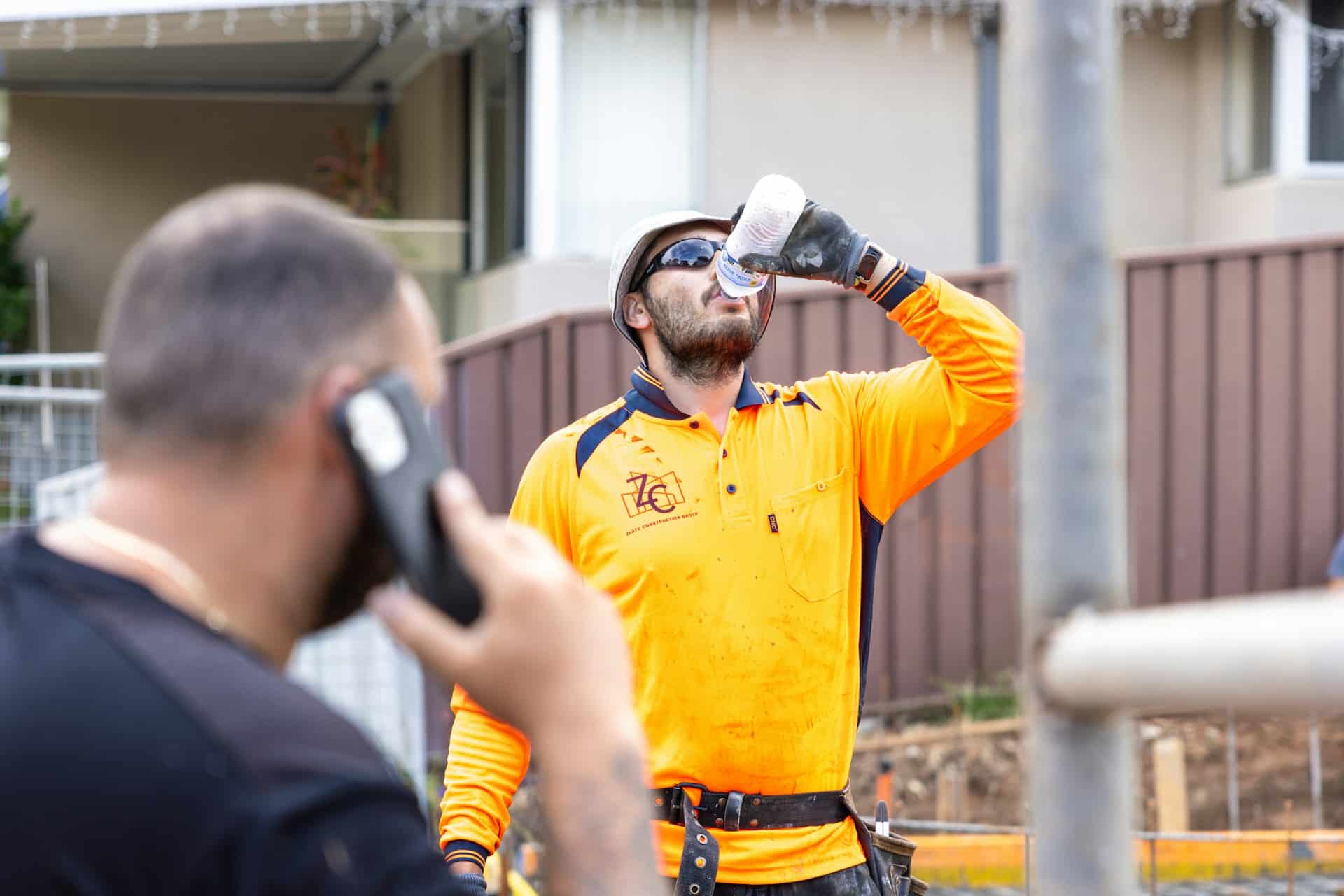 construction worker drinking water in a heat wave